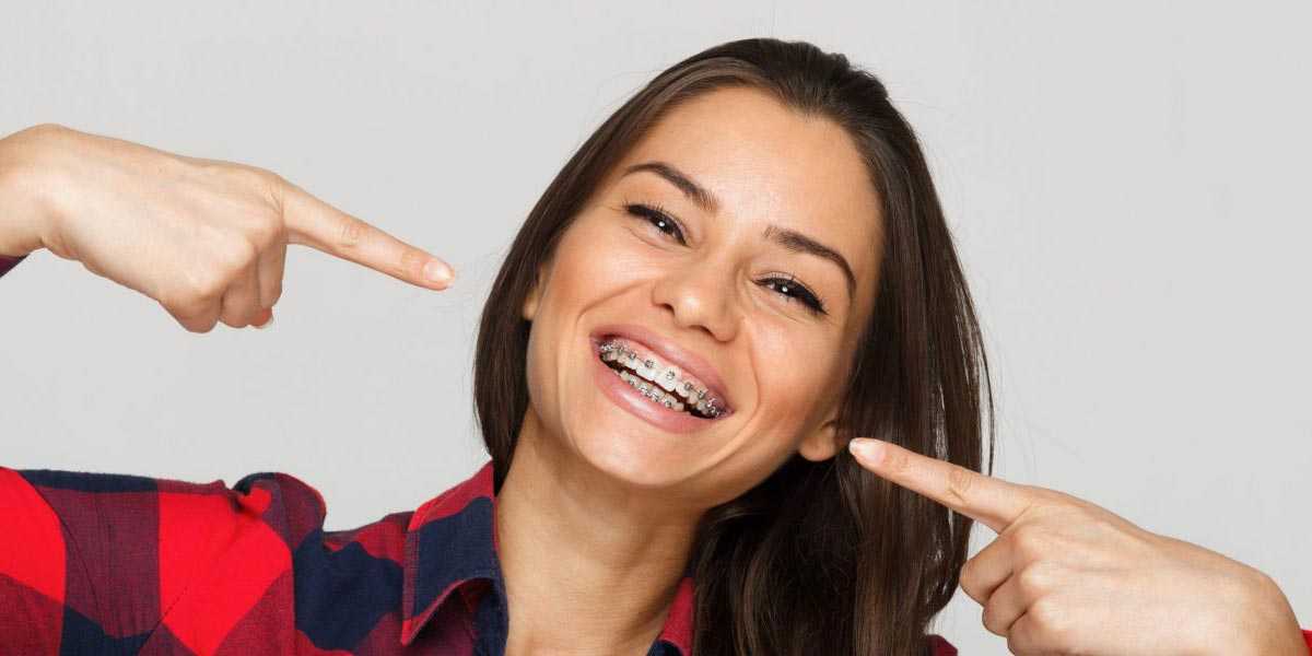 Woman Pointing At Her Braces Woman Pointing At Her Braces